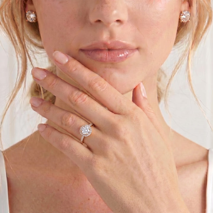 Video showing a round gemstone engagement ring worn on a model's hand.