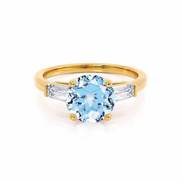 LOVETTA - Round & Baguette Chatham® Aqua Spinel 18k Yellow Gold Trilogy Engagement Ring Lily Arkwright