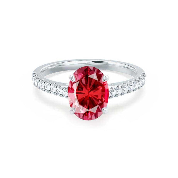 Oval shaped adjustable red ruby ring in platinum finish lined with cz  baguettes -